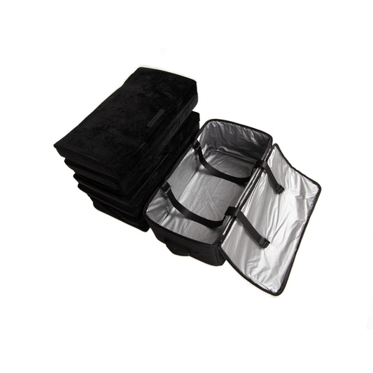 The folded black EV-MATS memory foam mattress next to its black carrying bag, which stands open to show the silver waterproof lining.