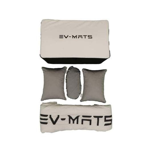 The EV-MATS Basic Camp Set laid out on a white background: the folded mattress in its white EV-MATS cover at the top, three grey pillows in the middle and the white EV-MATS duvet rolled up at the bottom.